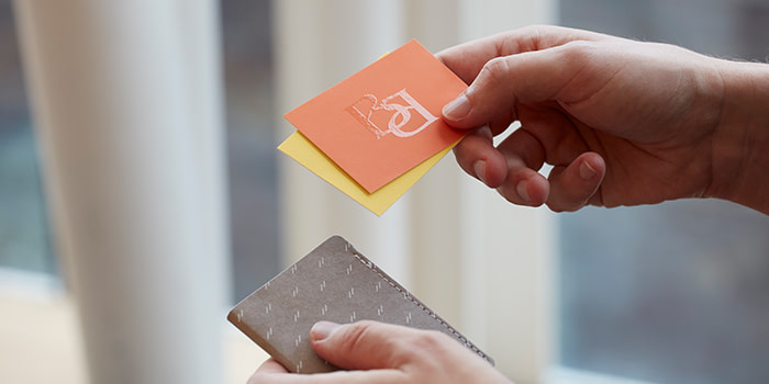 Someone handing out multiple Business Cards.