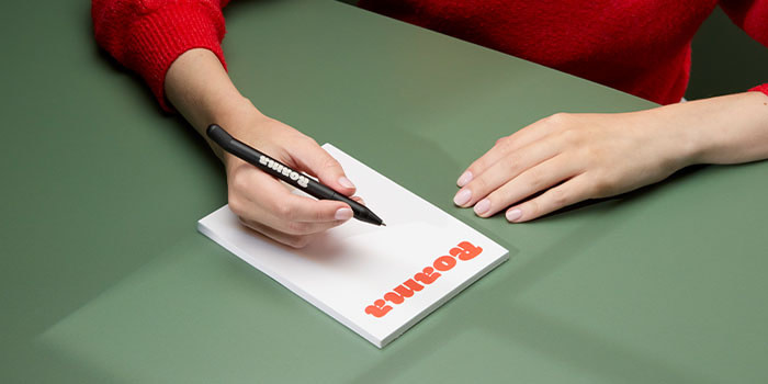 Employee writing on Notepad.