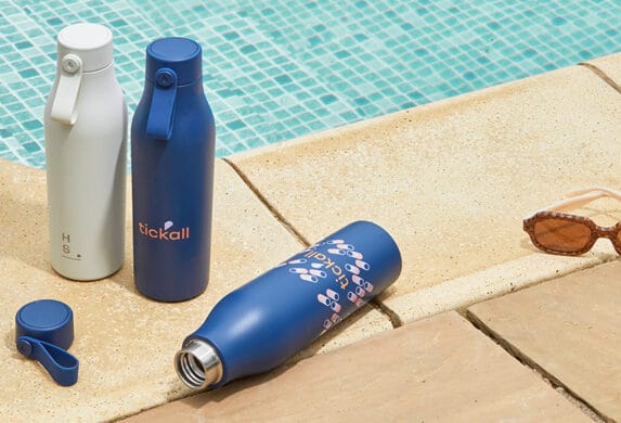 Branded water bottle products next to a poolside