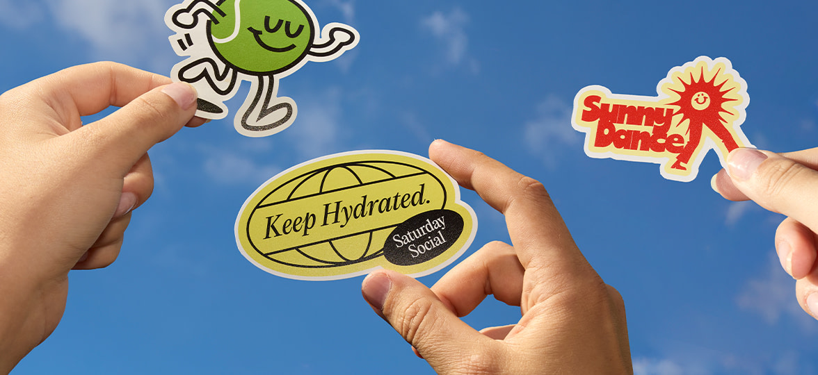 People holding Die cut Stickers in the air.