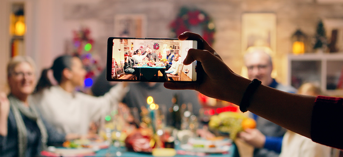 Someone taking a photo of a holiday scene with a phone