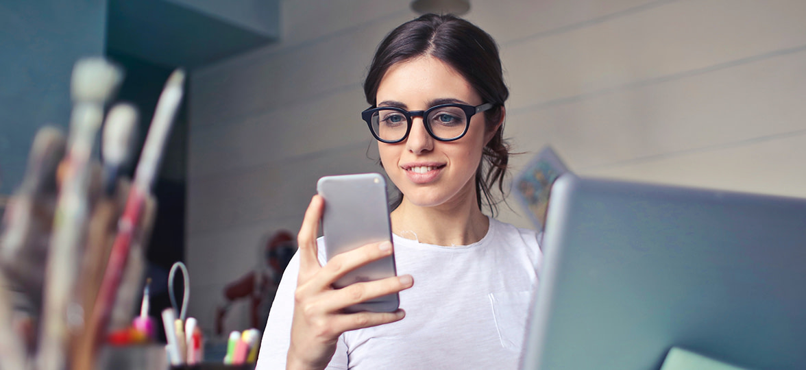 person checking phone at desk