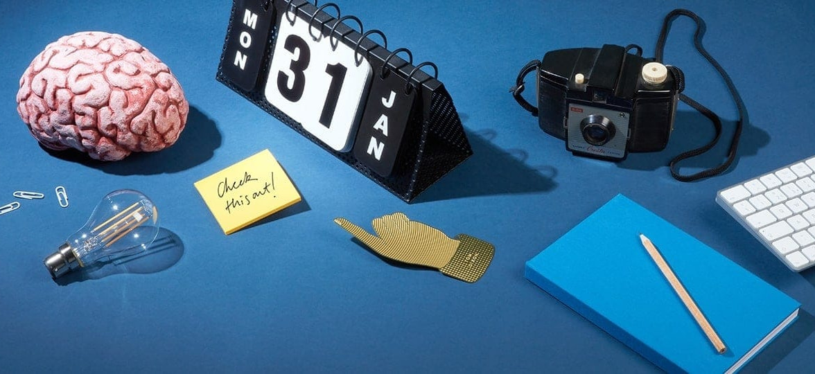 Brain, perpetual calendar and other accessories on a blue table