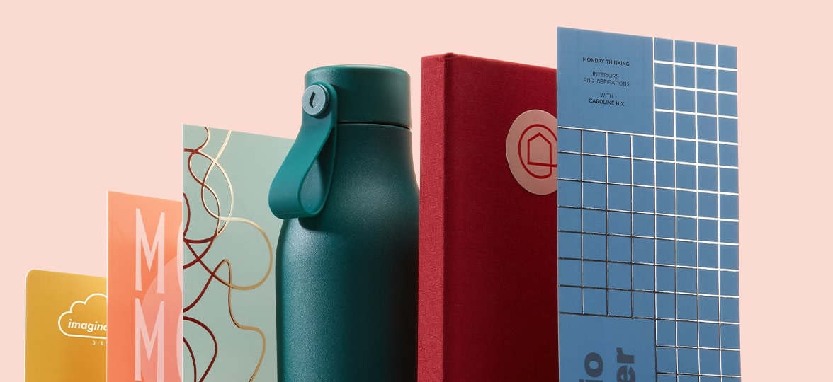 Growth graph made of custom prints and branded merch including business cards, postcards, a water bottle and a notebook