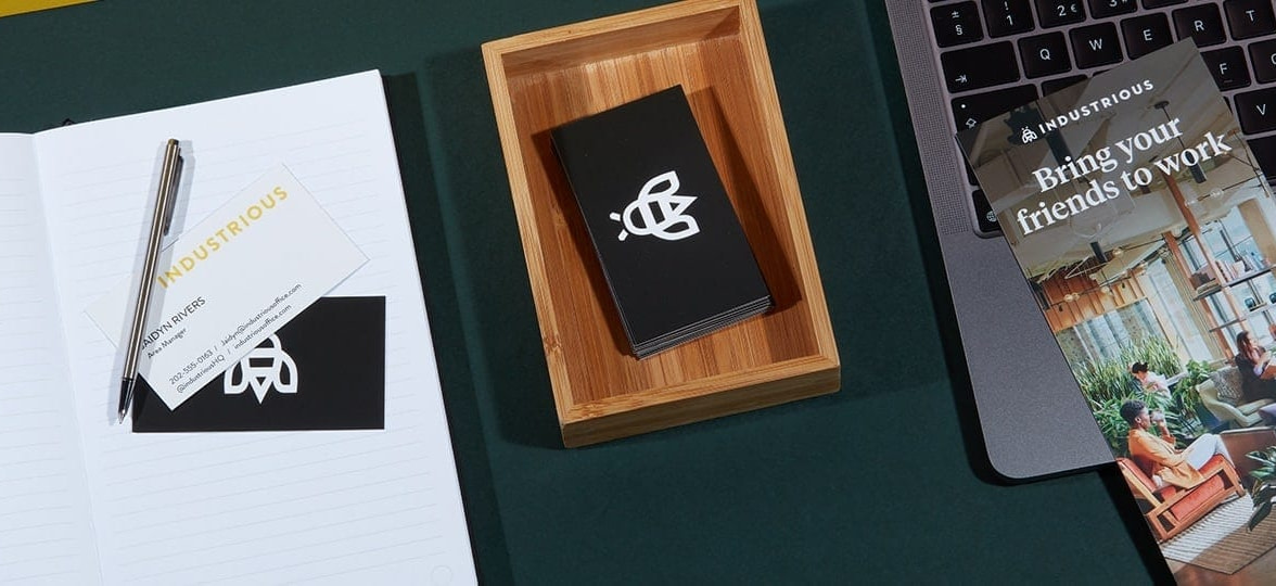 Industrious referral rack card, black business card with a bee logo and other marketing collaterals by Industrious