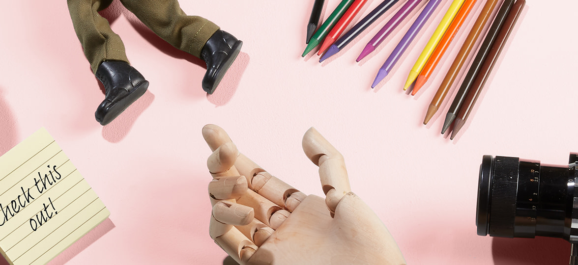 Toys and pencils on a pink table