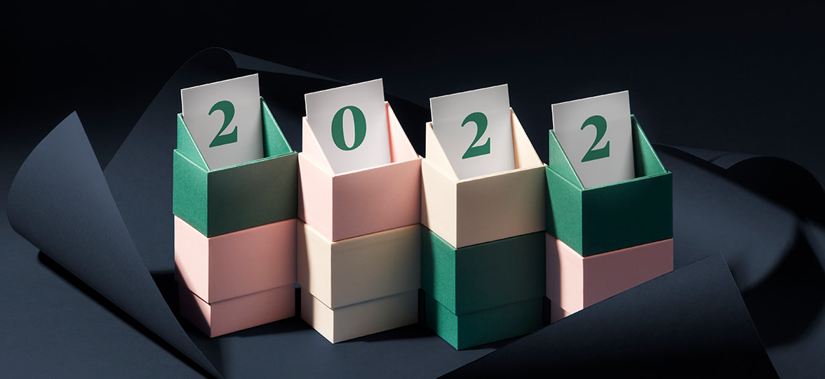 Business cards peeking out of display boxes spelling out 2022