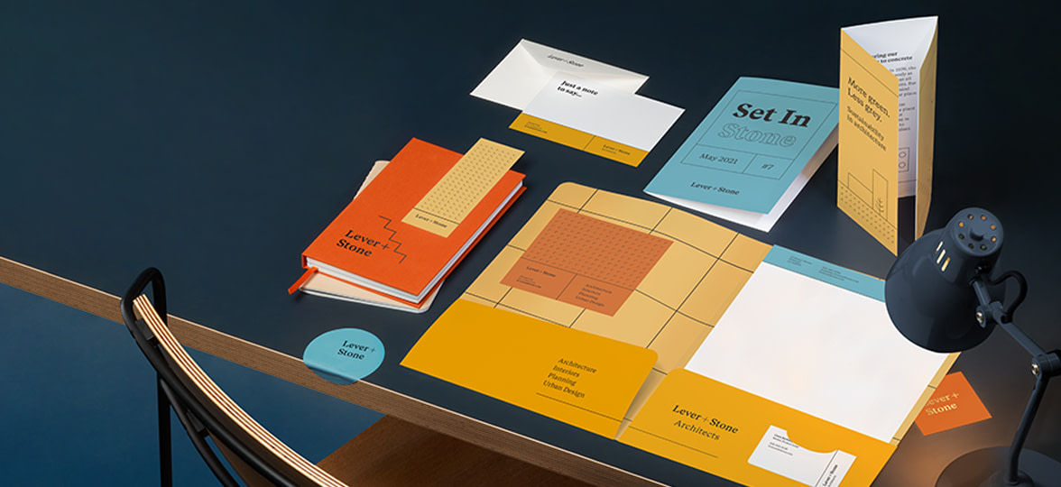 Custom folder, brochure, postcard, bookmark and notecard displayed on table.
