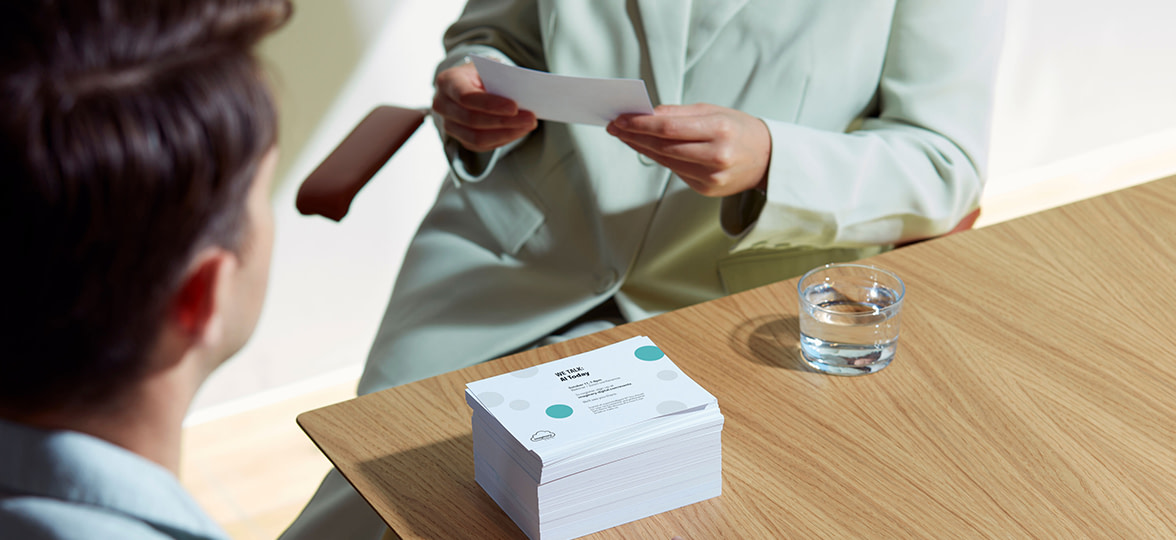 Eco paper Postcards being held by employee.