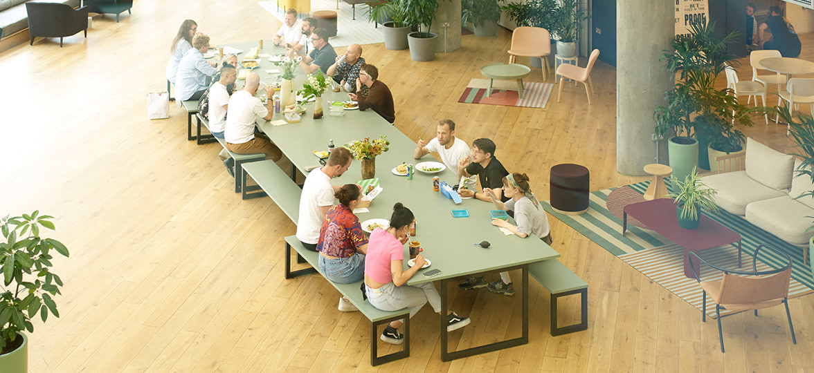 A group of MOO colleagues sitting and having lunch together