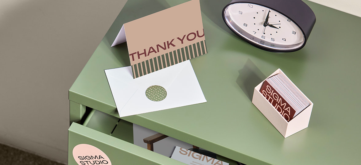 A thank you card with an envelope and business cards