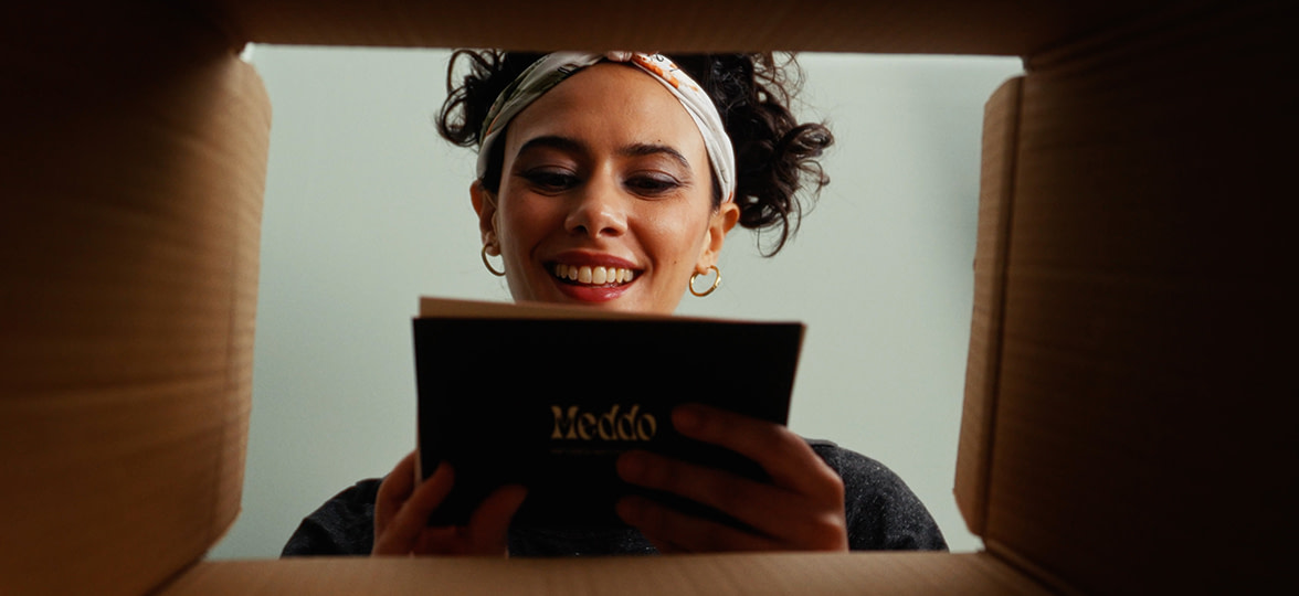 Woman opening her MOO order.