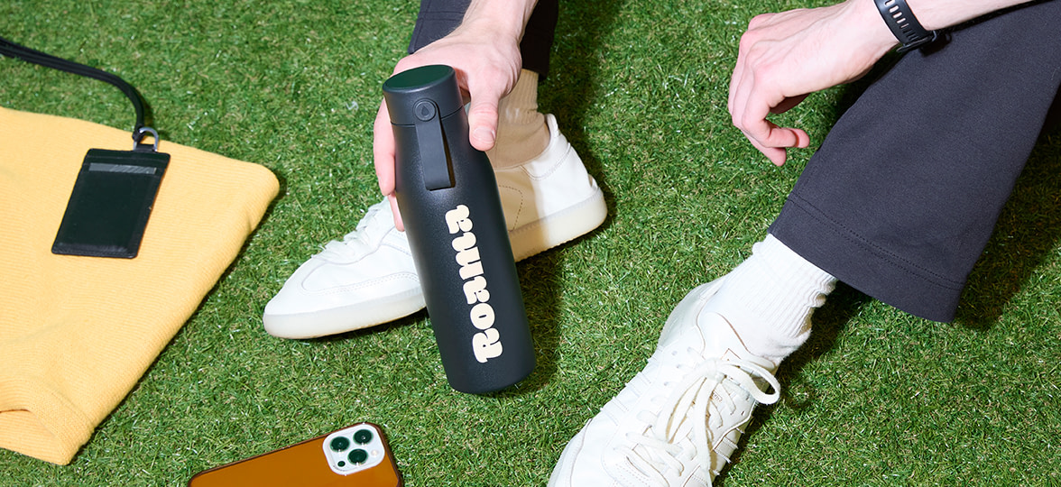 A person enjoying an outdoor event with their MOO Branded Water Bottle.