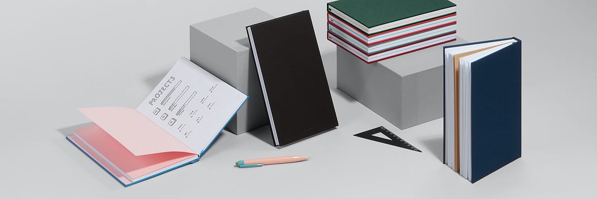 Collection of 7 colored hard cover notebooks for work