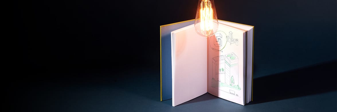 MOO Hardcover Notebook open to a page with doodles and notes under a lit light bulb for Innovation Day