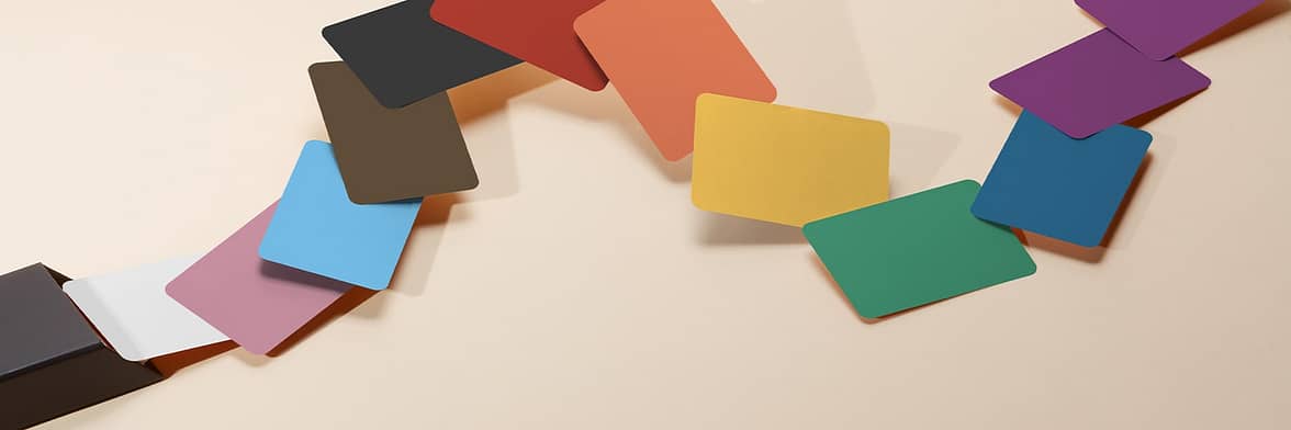 Collection of business cards arranged like a color fan, each card in a different color to evoke the rainbow flag and with a different color thanks to Printfinity
