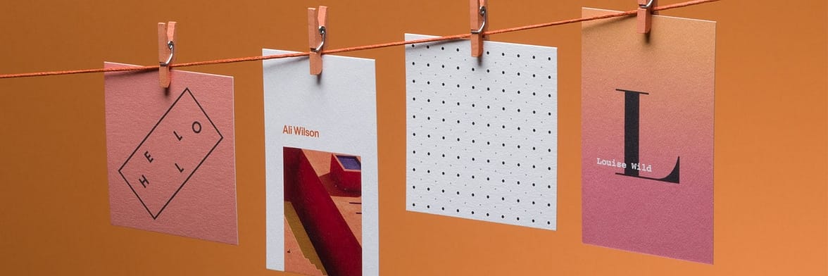4 recycled cotton business cards in different sizes and designs hanging on a washing line
