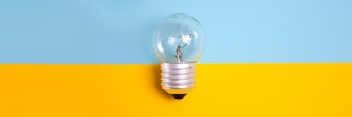 Light bulb on a yellow and blue background