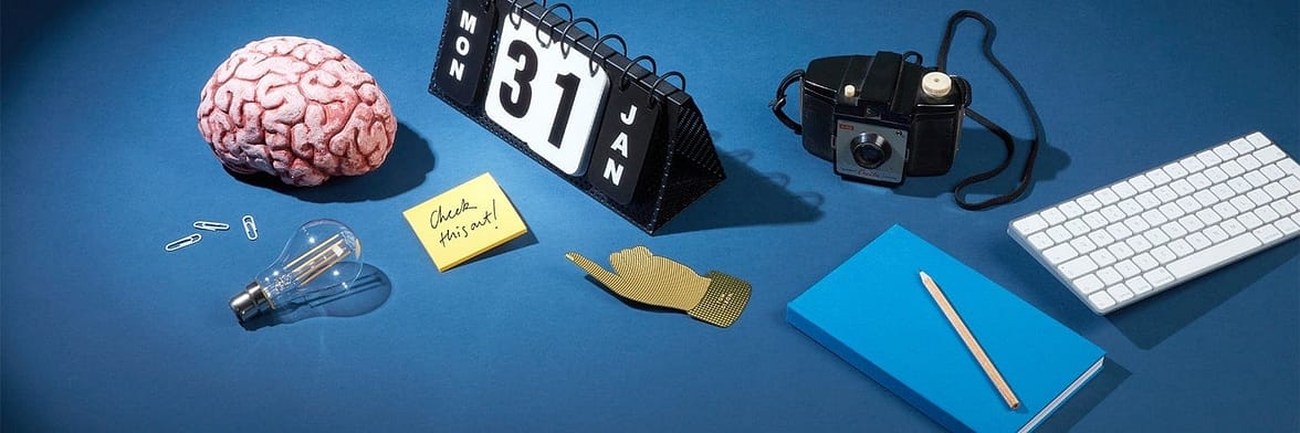 Brain, perpetual calendar and other accessories on a blue table