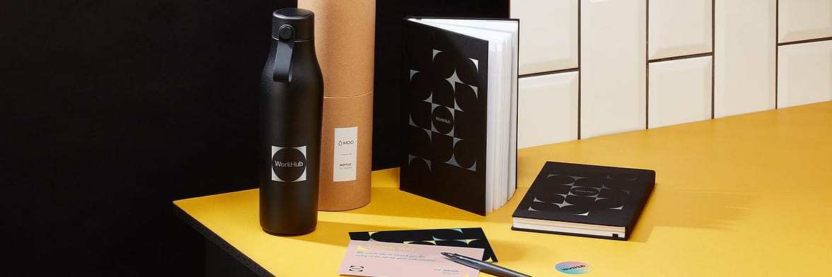 Black water bottle, custom notebooks and print products