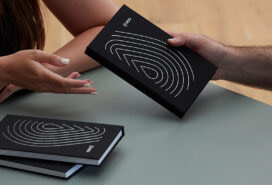 Branded work planner being gifted from one employee to another.