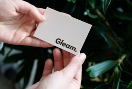 Velvet touch business card from MOO being held by a customer
