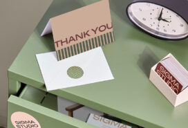 A thank you card with an envelope and business cards