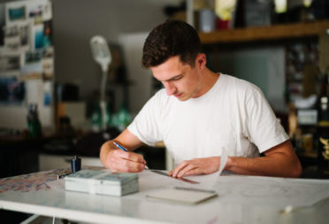 Archie Proudfoot designing signs