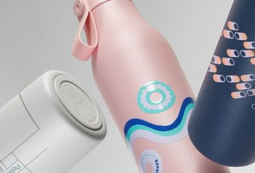 Thre custom water bottles in grey, pink and blue with various designs