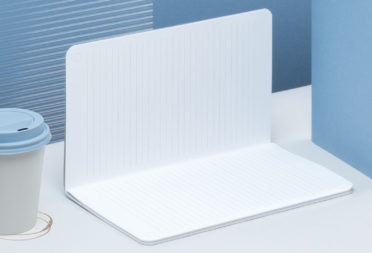 Open softcover journal, blue soft cover notebook and coffee cup