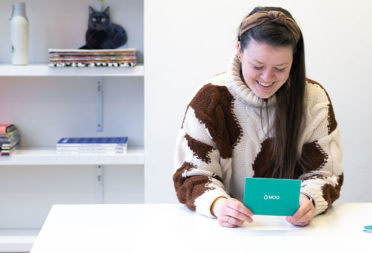 Portrait of Radvile Didvale, software engineer at MOO, reading a question card