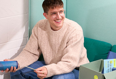 A man interacting with MOO's new welcome box