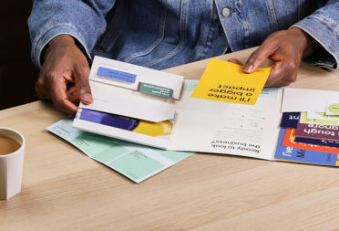 A MOO presentation folder with a variety of print products