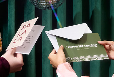 People holding a Postcard and a Greeting card.