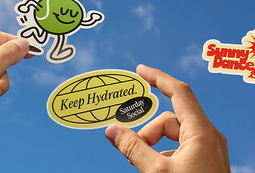 People holding Die cut Stickers in the air.