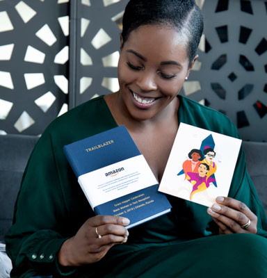 Cimone Key holding personalised MOO notebook and her illustration printed on a flyer