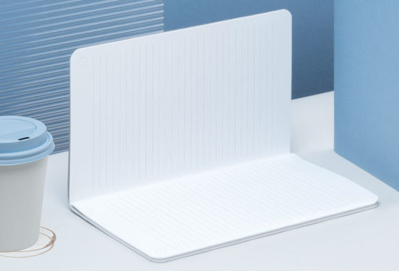 Open softcover journal, blue soft cover notebook and coffee cup