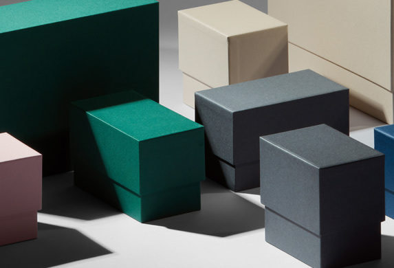 Pink, green, grey, beige and navy blue display boxes for business cards and postcards