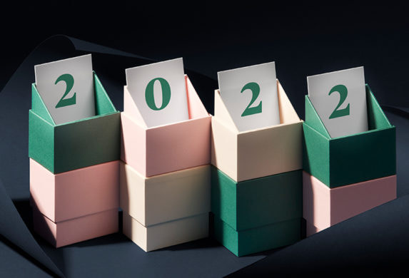 Business cards peeking out of display boxes spelling out 2022