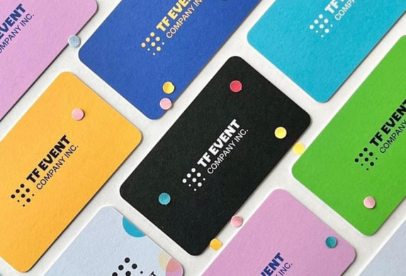 TF creative business cards laid flat on table.