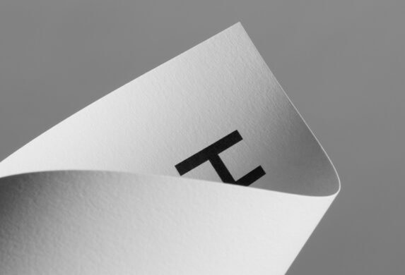A curved piece of paper with a logo on it