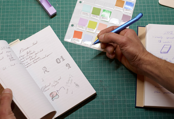 Person working on design ideas with a MOO Notebook.