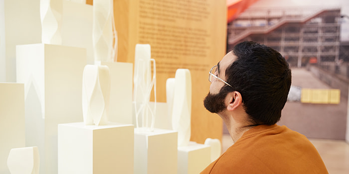 MOO employee looking at sculptures in the London design museum