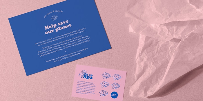 Pink table and tissue paper, blue postcard and pink loyalty card