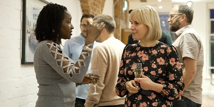 People chatting at the MOO party