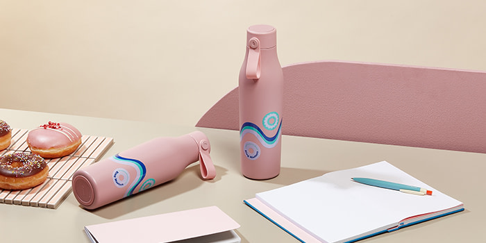 Pink custom water bottles and notebooks