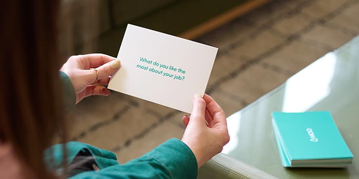 Ellie holding a question card