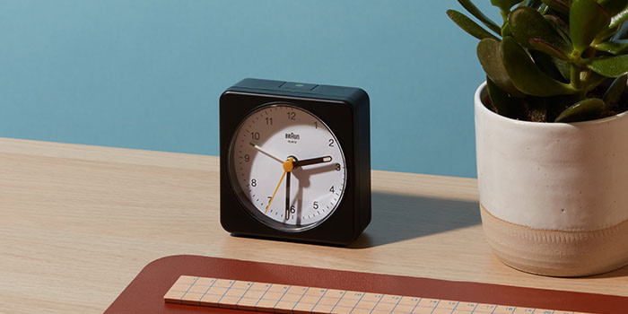 Tidy decluttered desk with clock