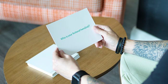 Milda holding a question card