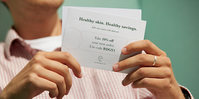 Eco paper Postcards being held by customer.